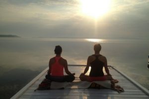 Vacation getaway morning meditation on dock at the Presidents' Suites and enjoying the sunrise on lake Temiskaming. / Méditation du matin sur le quai aux Suites des Présidents en profitant du levée de soleil sur le lac Témiskaming.