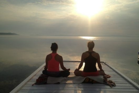 Vacation getaway morning meditation on dock at the Presidents' Suites and enjoying the sunrise on lake Temiskaming. / Méditation du matin sur le quai aux Suites des Présidents en profitant du levée de soleil sur le lac Témiskaming.