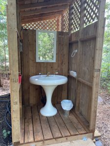 Shaving sink attached to shower facility for glamping