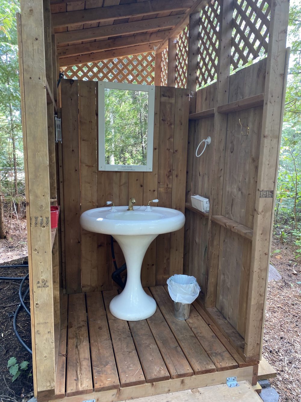Shaving sink attached to shower facility for glamping