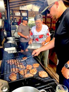 Cooking hamburgers on Farr Island glamping